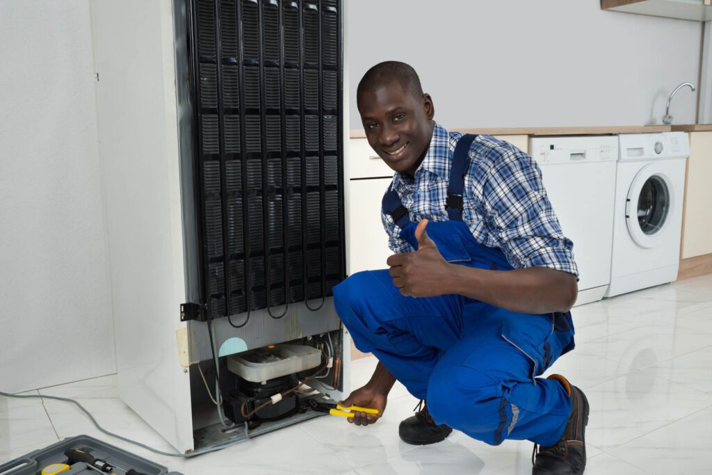 Technician fixing refrigerator m